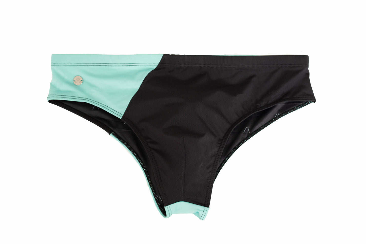A classic swim brief with a color block design, featuring top and bottom halves in Glacier Blue and Volcanic Black respectively, with a small logo on the lower left side.