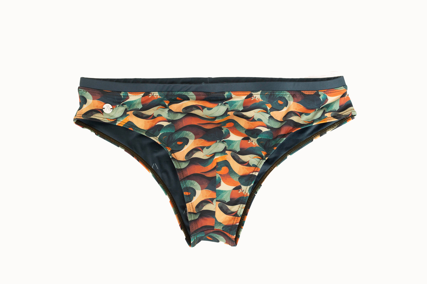 A multicolor swim brief with a tropical jungle waves pattern, predominantly in shades of green, orange, and black.