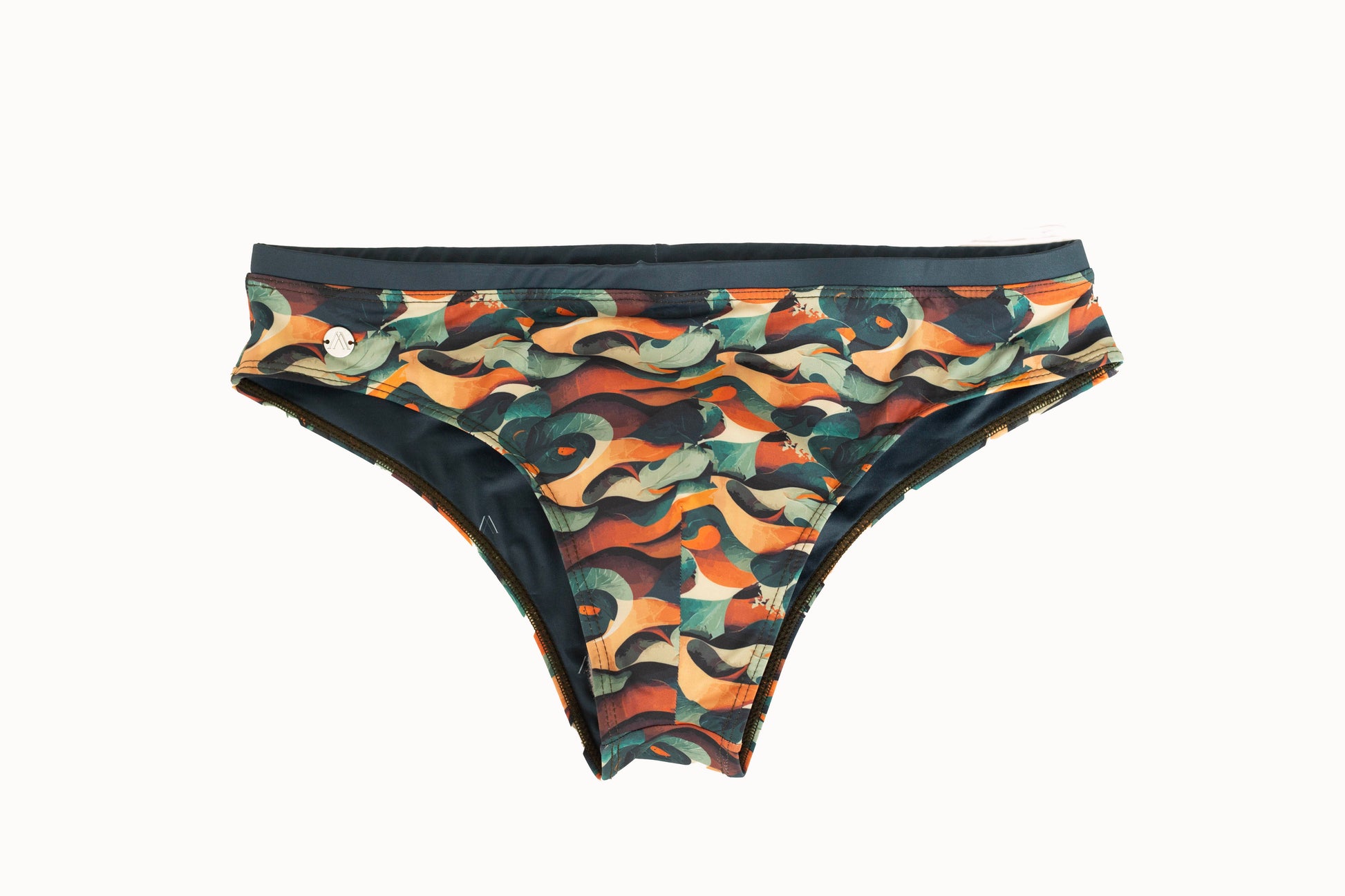 A multicolor swim brief with a tropical jungle waves pattern, predominantly in shades of green, orange, and black.