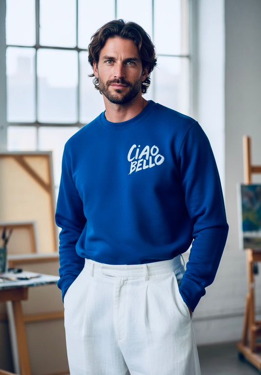 Man wearing a blue sweatshirt with 'CIAO BELLO' text in an indoor setting