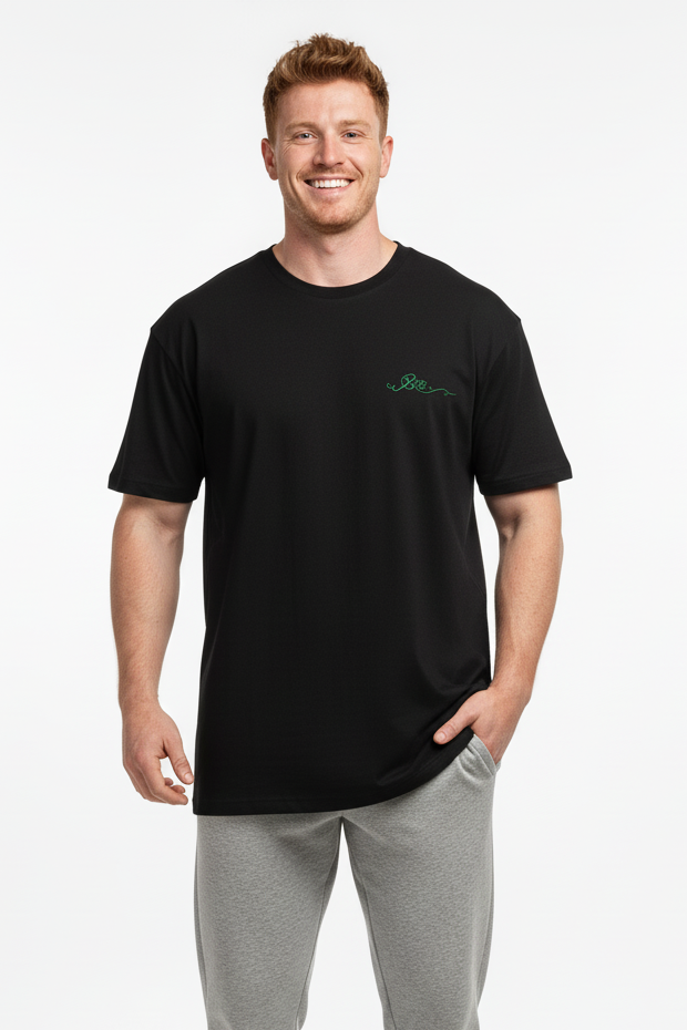 Man wearing a black t-shirt and gray pants on a white background