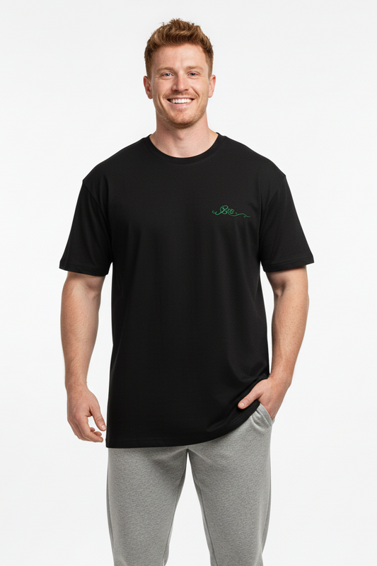 Man wearing a black t-shirt and gray pants on a white background