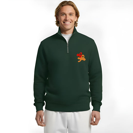 man wearing a forest green half-zip sweater with embroidered art logo