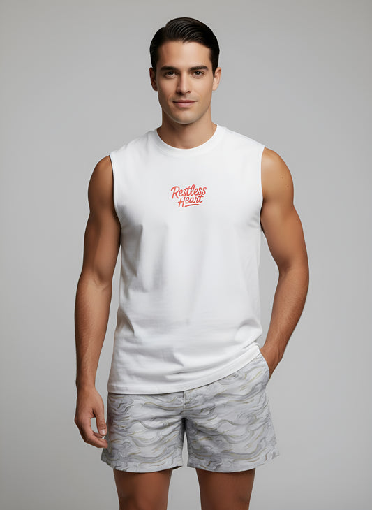 man wearing a muscle tank top with the words restless heart embroidered 